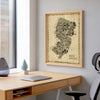 Iconic New Jersey Antique Edition vintage map artwork framed in natural wood above a modern home office desk. Detailed sepia wall art celebrating the Garden State with over 600 illustrated landmarks.