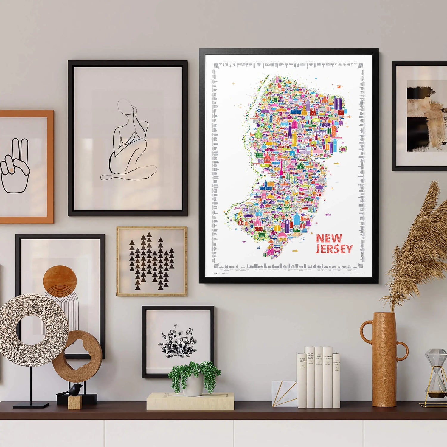 Colorful New Jersey city map art print framed in black wood, displayed in a modern gallery-style wall arrangement — elegant home decor by Alfalfa New York.