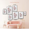 Colorful New York City Five Boroughs illustrated map poster size guide showing seven framed print sizes from 12 x 18 to 30 x 40 inches above a blush pink sofa.