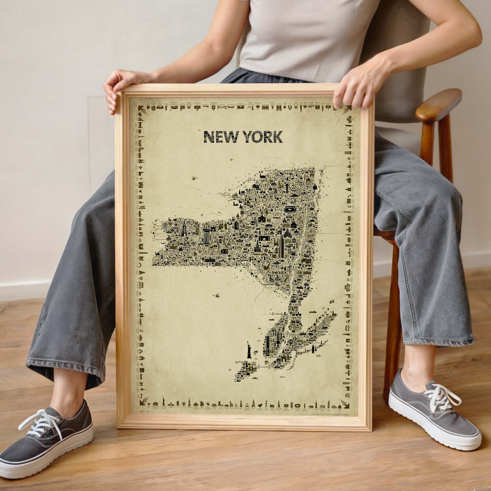 Woman holding the Iconic New York State Antique Map Poster in a natural wood frame, showing real-life scale for this vintage Empire State wall art print and travel souvenir.
