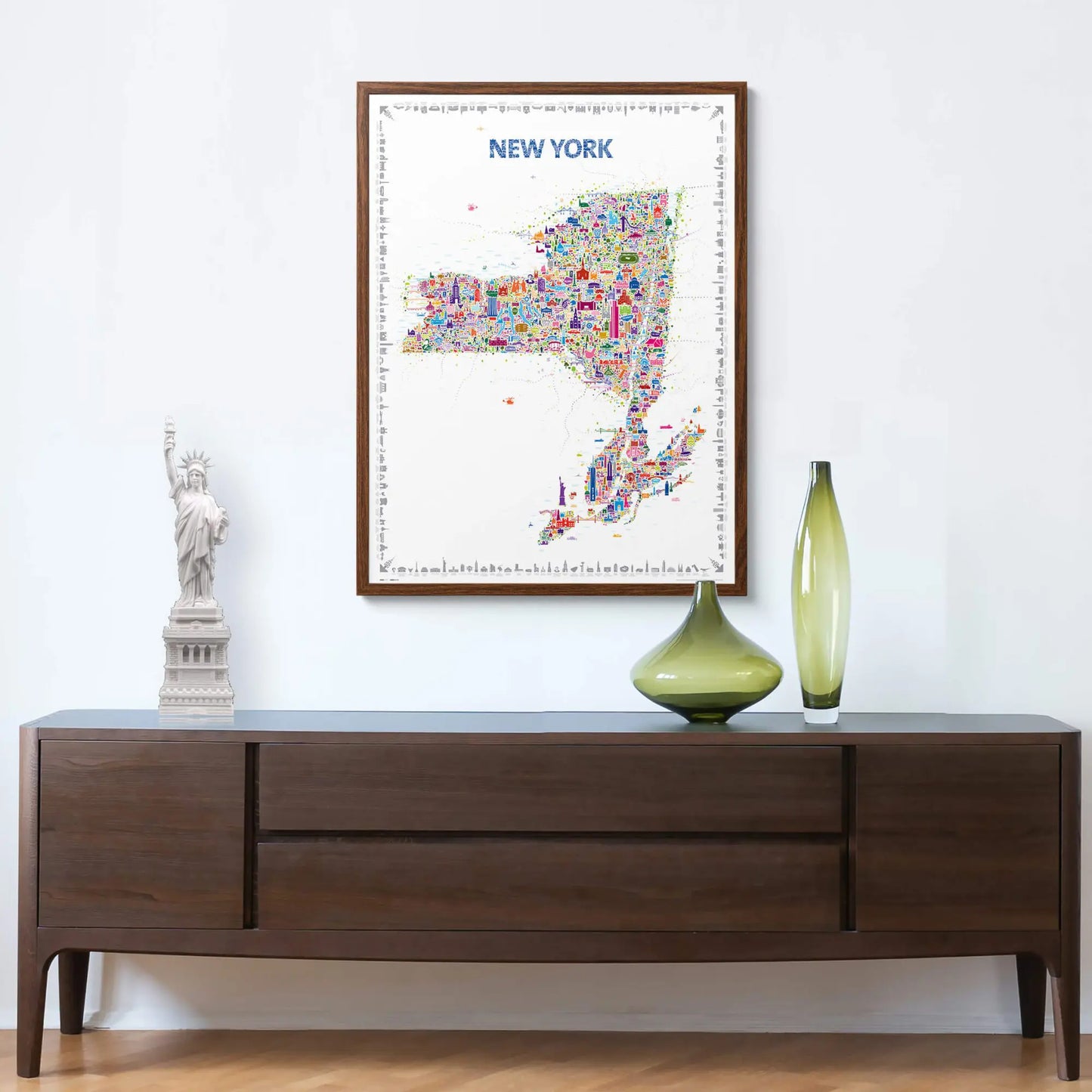 Framed map of New York on a wall above a wooden console table with decorative items.