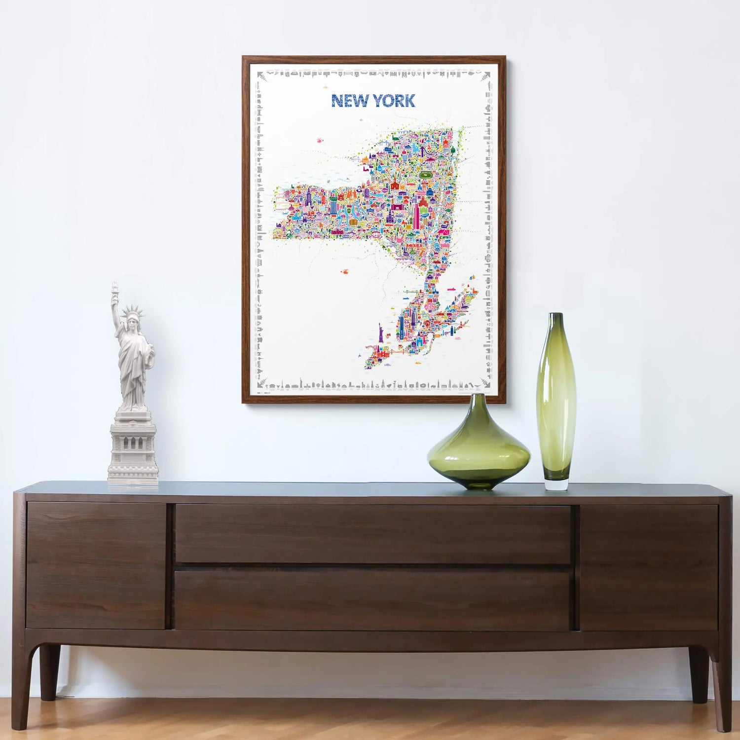Framed map of New York on a wall above a wooden console table with decorative items.