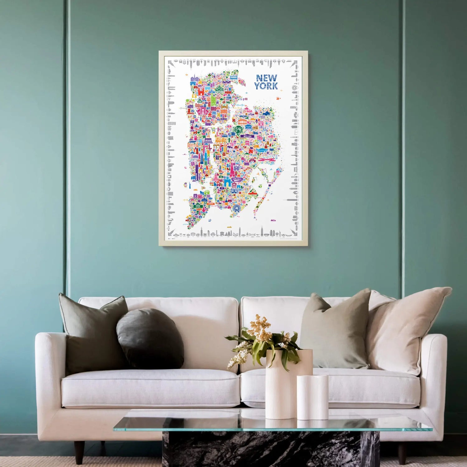 Alfalfa New York illustrated map poster of New York City framed on a teal wall above a modern sofa with neutral cushions and a glass coffee table.