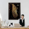 Woman working at a desk with a cat, framed map of New York on the wall.