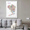 Framed Alfalfa New York Queens illustrated map poster hanging above a modern gray sofa with a white cat sitting in a cozy living room.