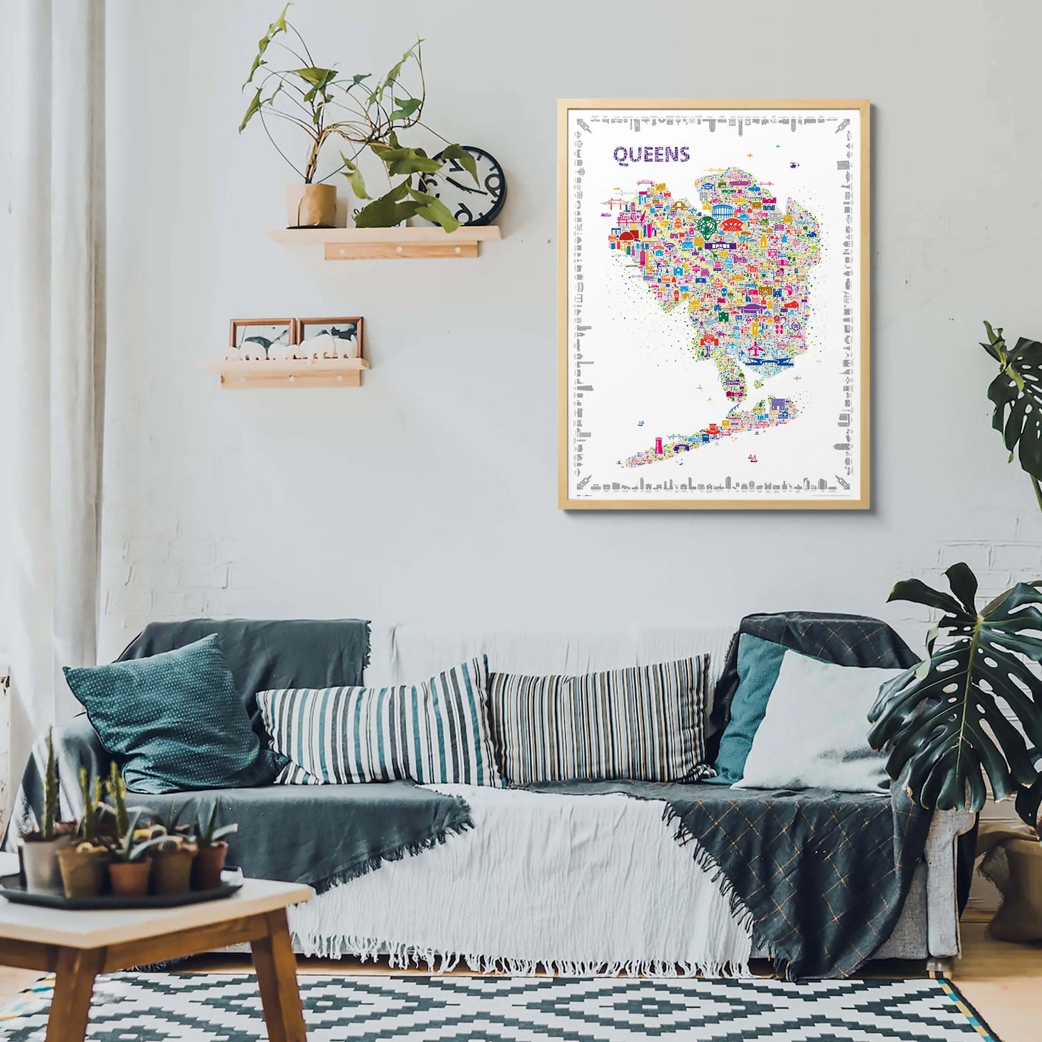 Living room with a colorful map of Queens on the wall above a sofa.