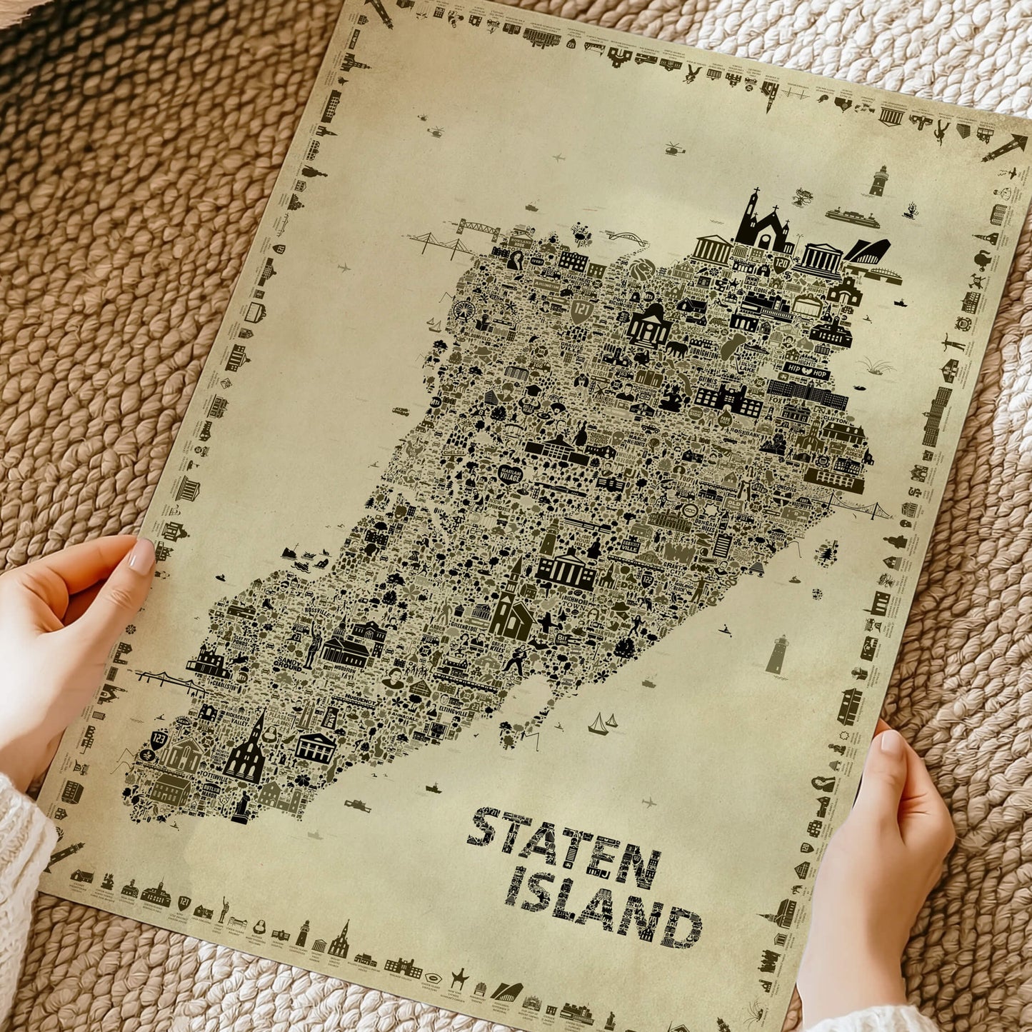 Hands holding the Iconic Staten Island Antique Edition printed on premium matte paper, highlighting the artwork's texture, quality and detailed vintage illustrated map.