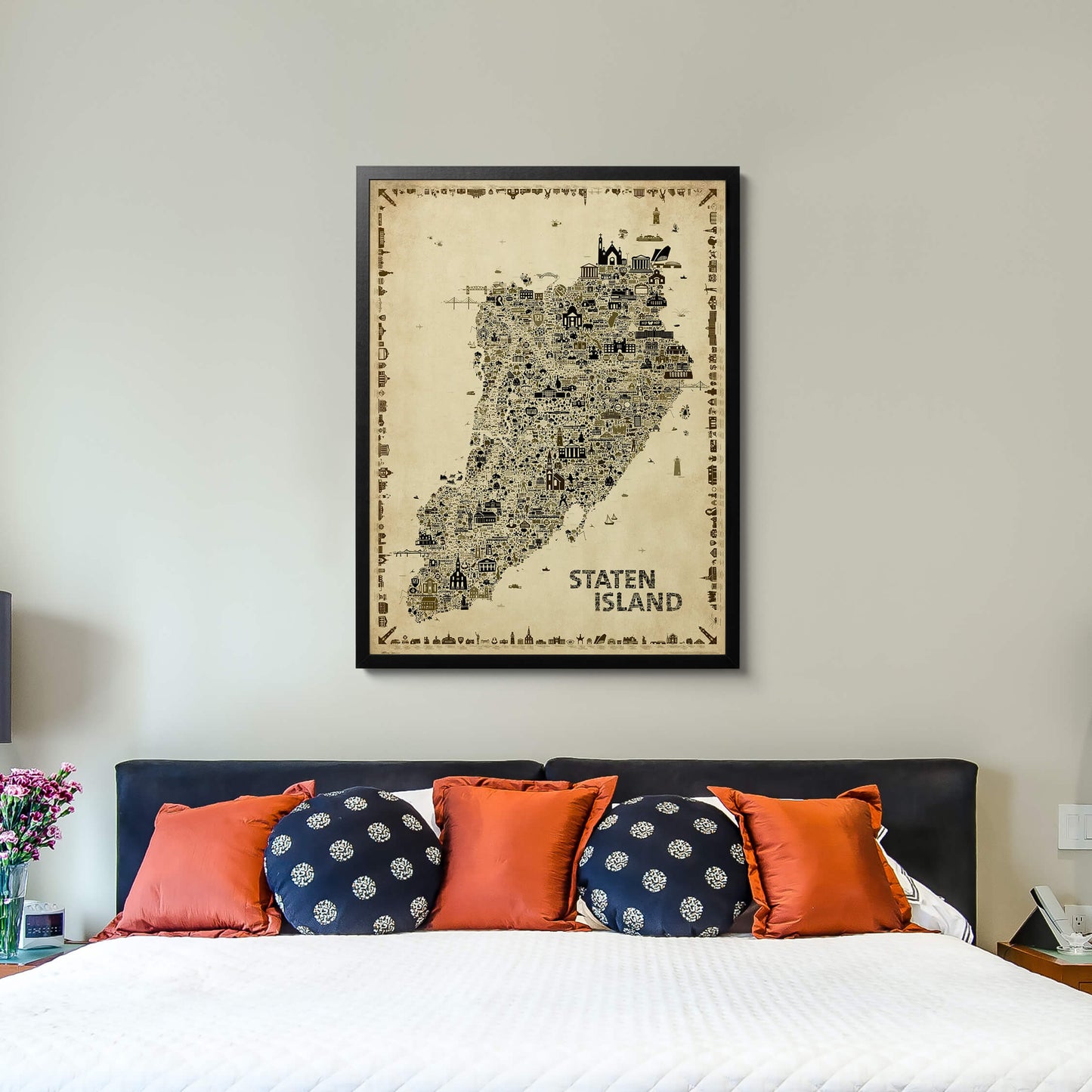 Black-framed Staten Island Antique Edition hanging above a bed, adding timeless vintage character and New York-inspired décor to a modern bedroom.