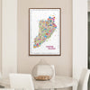 Colorful Staten Island map in a frame on a wall above a table with decorative elements.