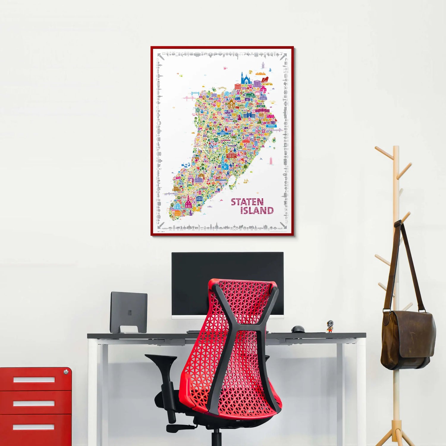 Colorful Staten Island map on a wall above a desk with a red office chair.