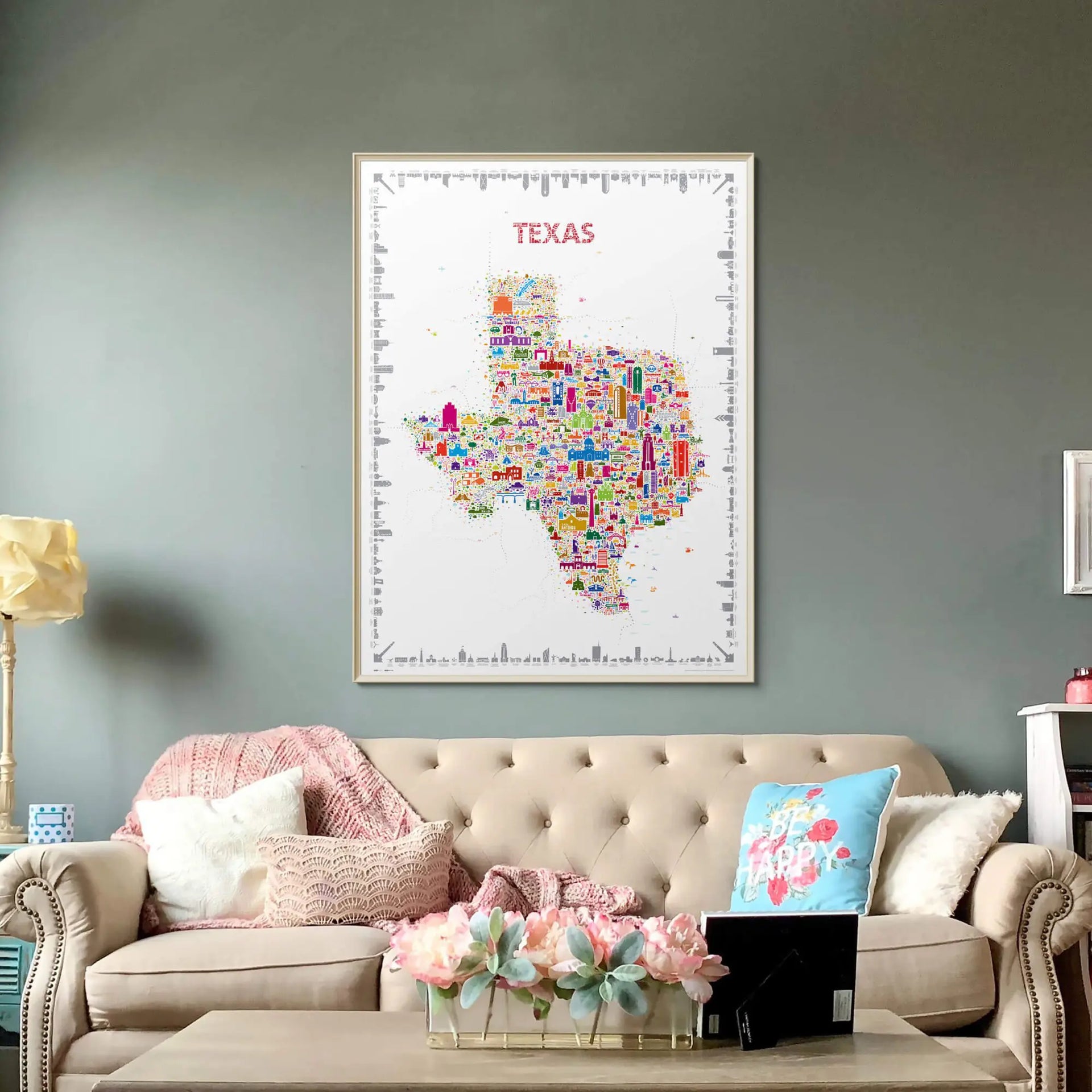 Colorful Texas map on a wall above a beige sofa with decorative pillows and a coffee table.