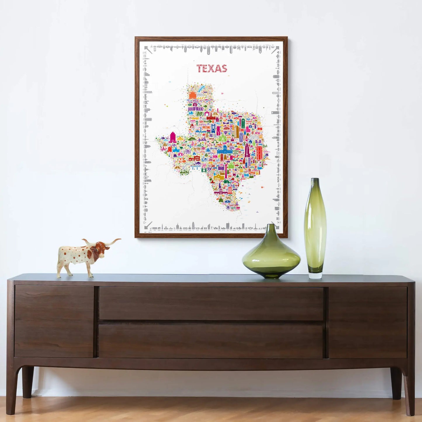 Colorful Texas map poster on a wall above a wooden console table with decorative items.