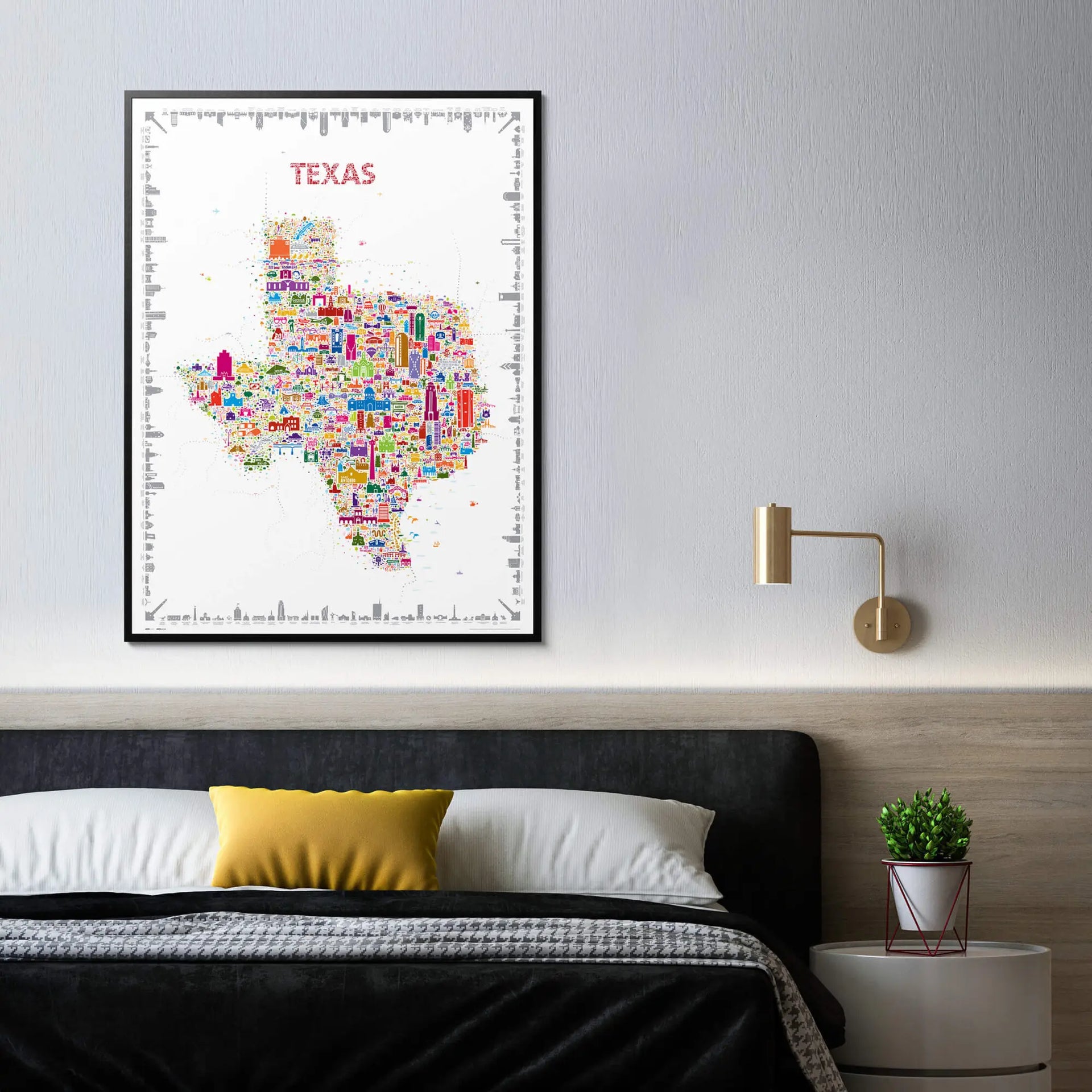 Colorful Texas map art print on a wall above a bed with a yellow pillow.