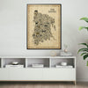 Framed The Bronx Antique illustrated map poster displayed above a modern white console cabinet with books, sculptural decor, a ceramic vase, and green houseplants.